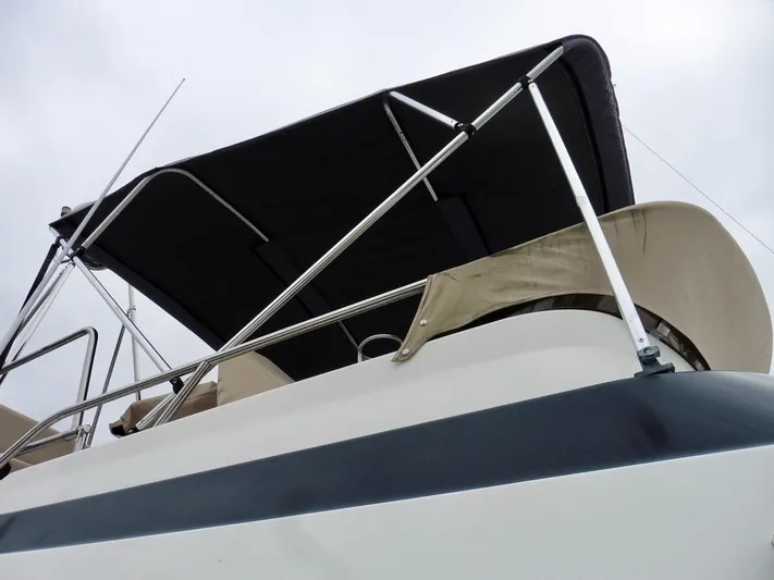  Yacht Photos Pics 2015 Cutwater 30CB boat with black canopy and railing, viewed from below.