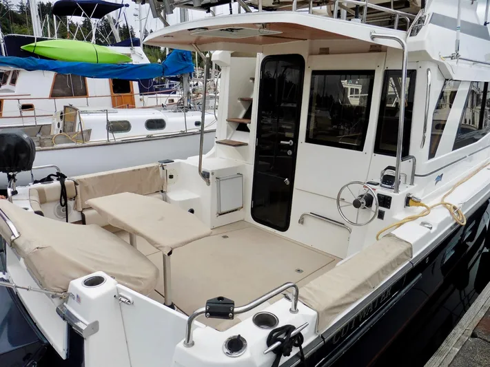  Yacht Photos Pics 2015 Cutwater 30CB boat with spacious deck and seating at marina.