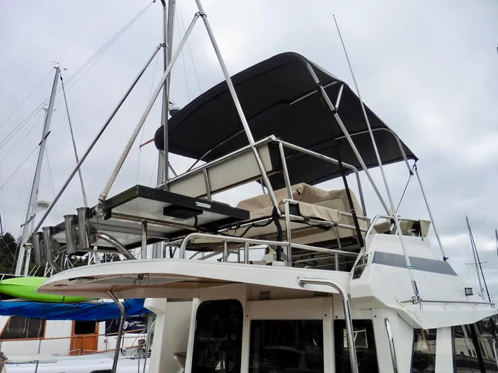  Yacht Photos Pics 2015 Cutwater 30CB boat with upper deck and canopy in marina.