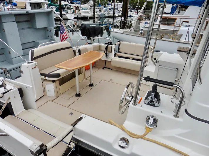  Yacht Photos Pics 2015 Cutwater 30CB boat with spacious seating and table in marina setting.