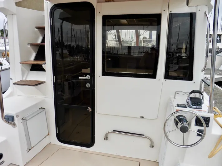  Yacht Photos Pics 2015 Cutwater 30CB boat cockpit with stairs, door, and steering wheel.