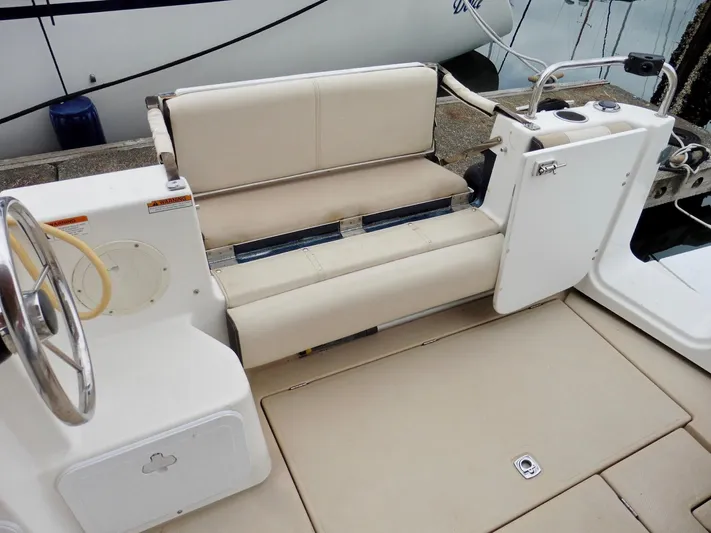  Yacht Photos Pics 2015 Cutwater 30CB boat interior with beige seating and steering wheel.