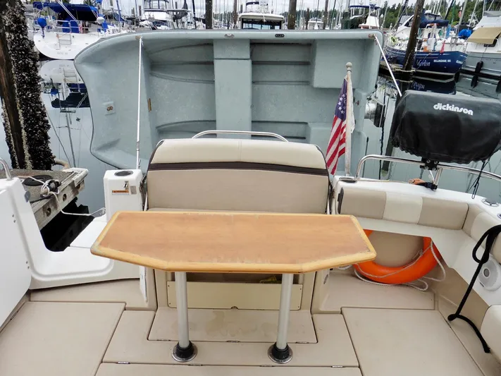  Yacht Photos Pics 2015 Cutwater 30CB boat interior with table, seating, and American flag in marina.