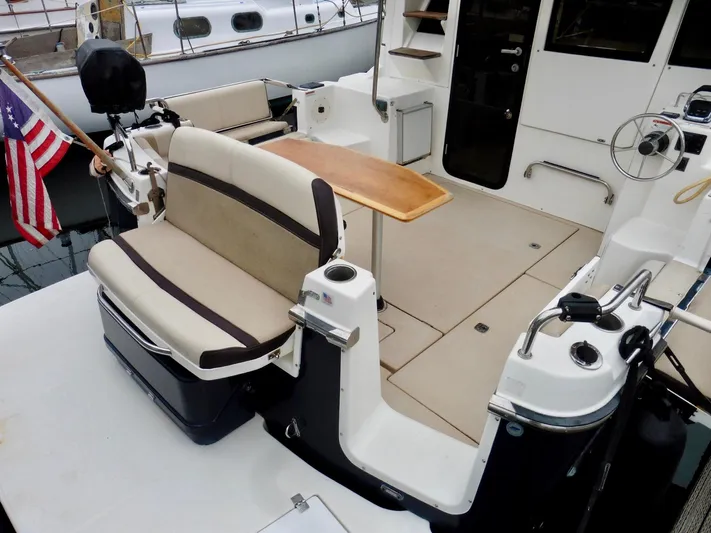  Yacht Photos Pics 2015 Cutwater 30CB boat interior with seating, table, and American flag.