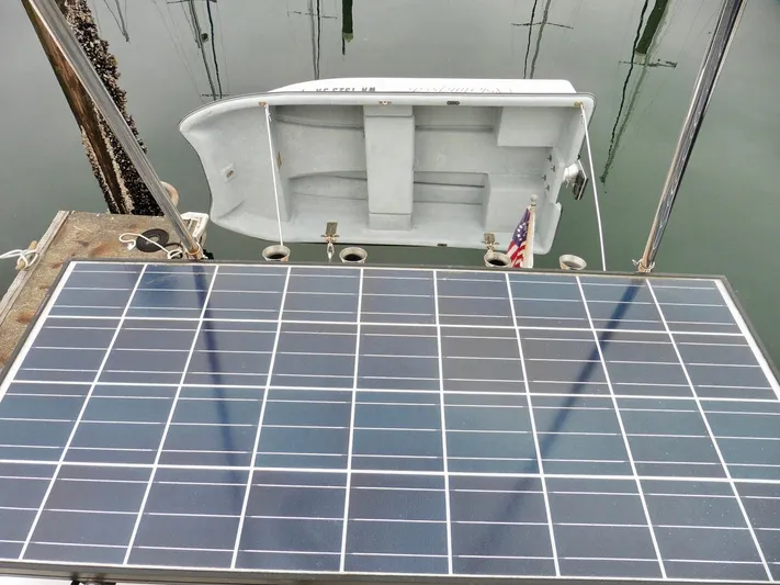  Yacht Photos Pics Solar panel on 2015 Cutwater 30CB boat with small dinghy in background.