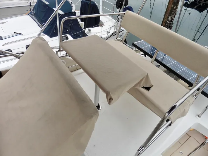 Yacht Photos Pics 2015 Cutwater 30CB boat seating area with beige covers and metal railings.
