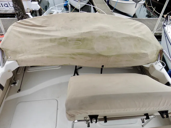  Yacht Photos Pics Covered seating area on a 2015 Cutwater 30CB boat at a marina.
