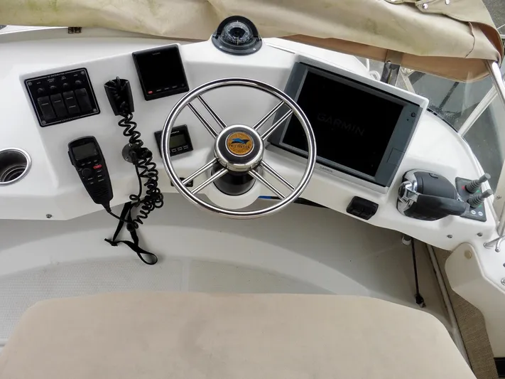  Yacht Photos Pics Helm of 2015 Cutwater 30CB boat with steering wheel and navigation equipment.