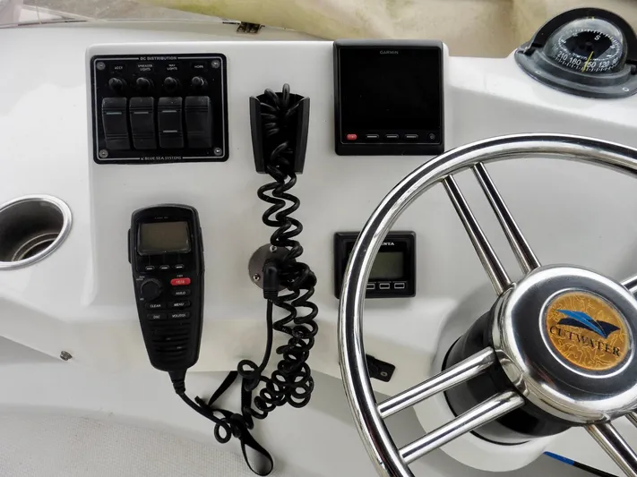  Yacht Photos Pics Cutwater 30CB 2015 boat dashboard with steering wheel, controls, and communication devices.