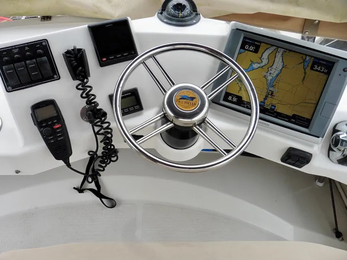  Yacht Photos Pics Cutwater 30CB 2015 boat helm with GPS, steering wheel, and communication devices.