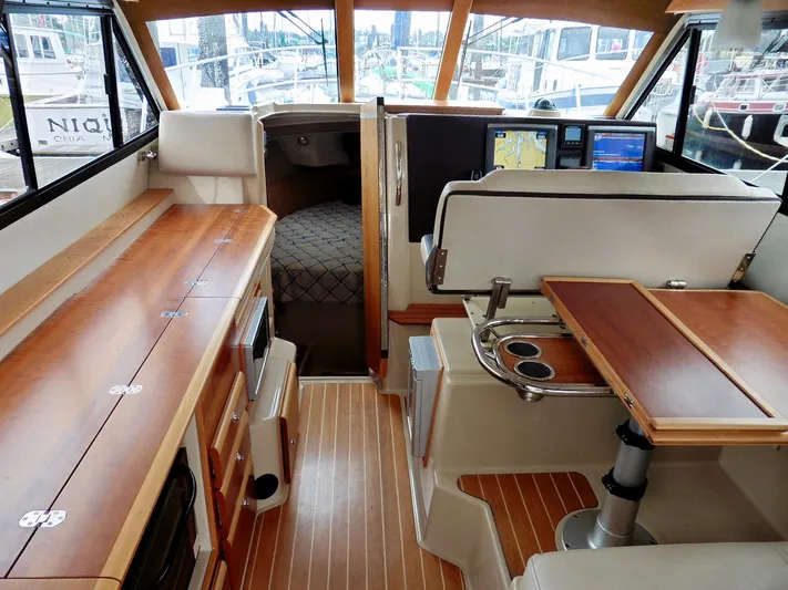  Yacht Photos Pics 2015 Cutwater 30CB interior with wood finishes, navigation screens, and cozy cabin space.