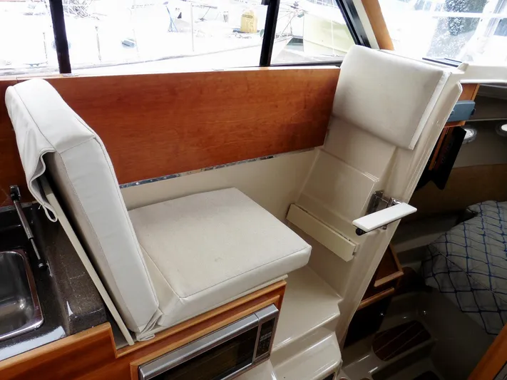  Yacht Photos Pics Interior of 2015 Cutwater 30CB boat with cushioned seating and wooden accents.