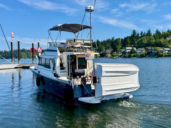  Yacht Photos Pics 2015 Cutwater 30CB boat docked on a sunny day, surrounded by calm waters and scenic views.