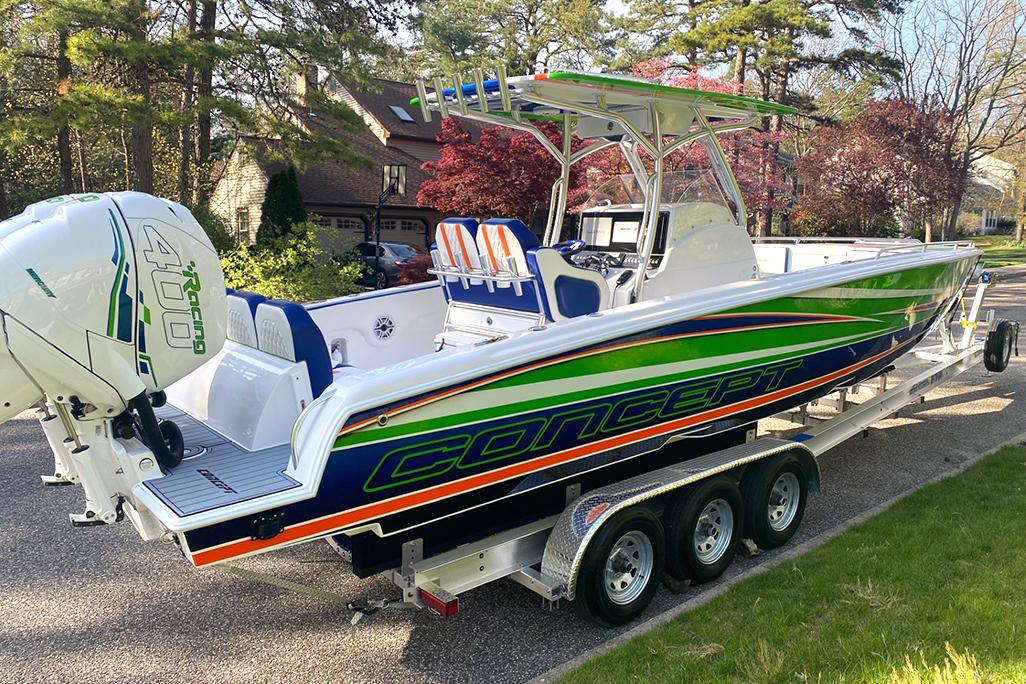 2020 Concept 36' Cuddy Cabin boat on a trailer, vibrant green and blue design.
