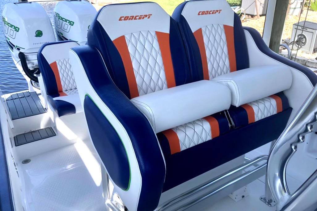 2020 Concept 36' Cuddy Cabin boat seats with blue, white, and orange upholstery.