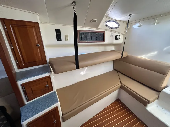  Yacht Photos Pics 1999 Carolina Classic 35 interior with beige seating, wooden cabinets, and nautical decor.