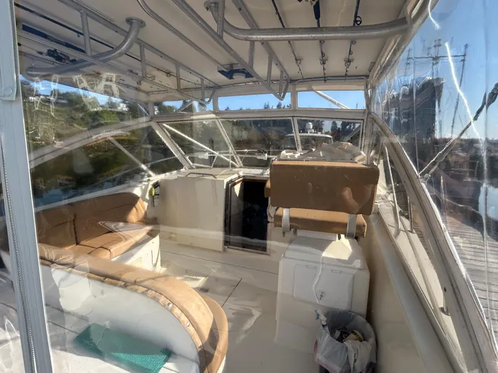  Yacht Photos Pics 1999 Carolina Classic 35 boat interior with seating and helm, featuring clear windows and sunny view.
