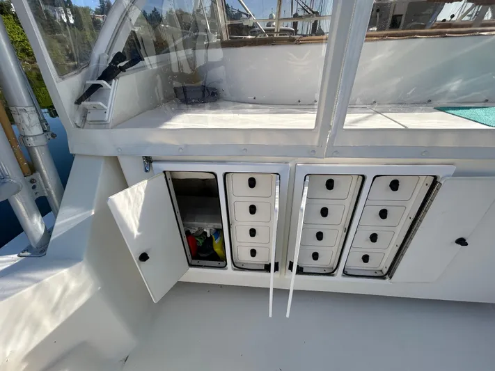  Yacht Photos Pics 1999 Carolina Classic 35 boat with open storage compartments and organized drawers.