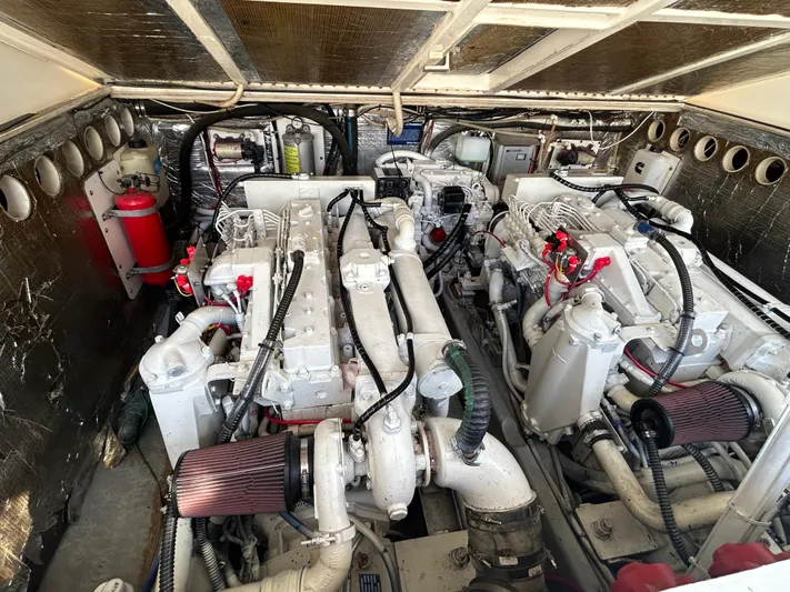  Yacht Photos Pics Engine room of a 1999 Carolina Classic 35 boat, featuring dual engines and mechanical components.