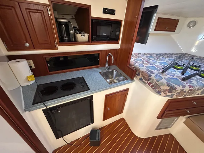 Yacht Photos Pics 1999 Carolina Classic 35 interior with kitchenette, sink, and bed.