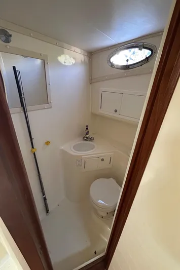  Yacht Photos Pics 1999 Carolina Classic 35 boat bathroom with sink, toilet, and window.