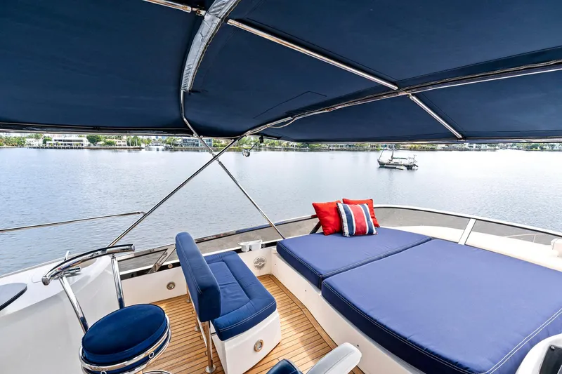 Persistence Yacht Photos Pics Luxurious 2006 Sunseeker 75 Yacht deck with blue seating and scenic water view.