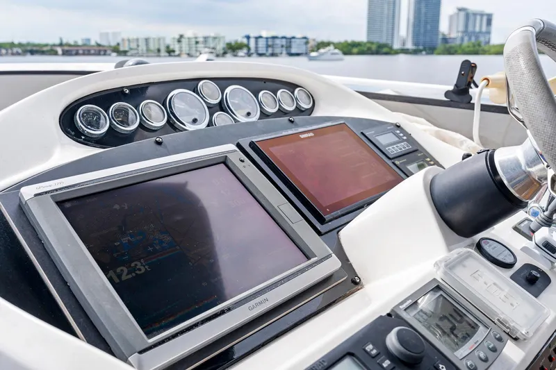 Persistence Yacht Photos Pics Control panel of a 2006 Sunseeker 75 Yacht with navigation screens and gauges.