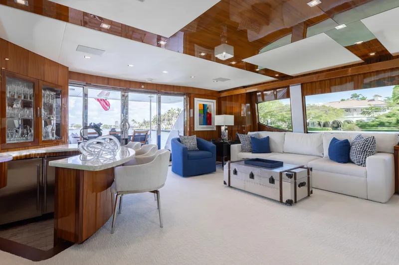 Ritz Sea Yacht Photos Pics Luxurious interior of 2014 Hatteras 80 Motor Yacht Sky Lounge with elegant furnishings and large windows.