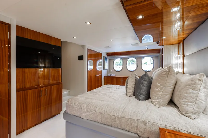 Ritz Sea Yacht Photos Pics Luxurious bedroom interior of 2014 Hatteras 80 Motor Yacht Sky Lounge with elegant wood finishes.