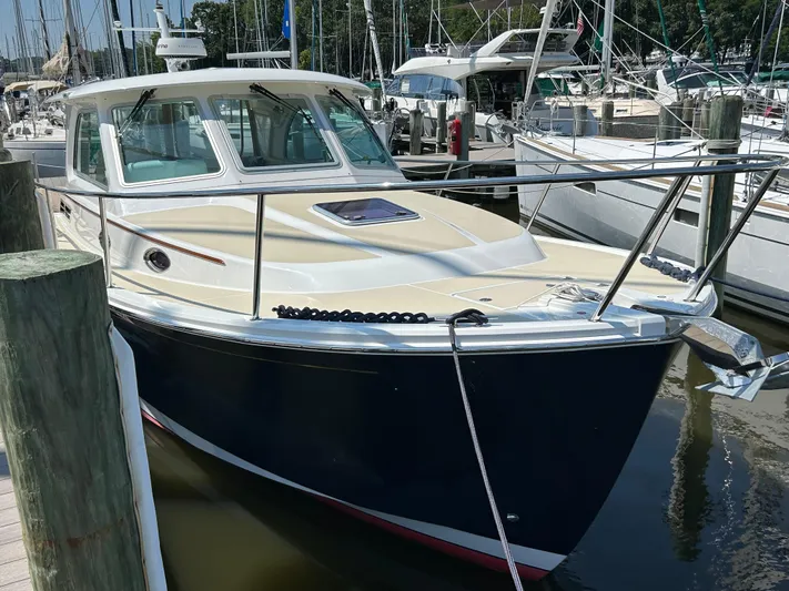 Islander Yacht Photos Pics 2018 Back Cove 32 boat docked at a marina, surrounded by other vessels.