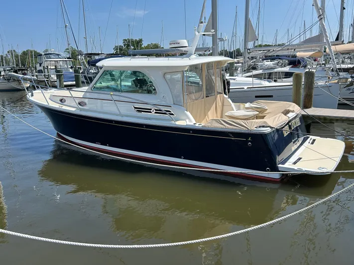 Islander Yacht Photos Pics 2018 Back Cove 32 boat docked in marina, surrounded by other vessels.