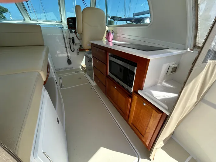 Islander Yacht Photos Pics Interior of 2018 Back Cove 32 boat with kitchenette and seating area.