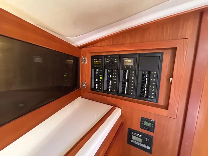 Islander Yacht Photos Pics Electrical panel inside a 2018 Back Cove 32 boat, featuring wooden cabinetry.