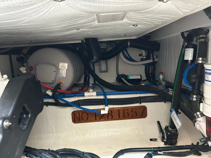 Islander Yacht Photos Pics Engine room of a 2018 Back Cove 32 boat, showing pipes and equipment.
