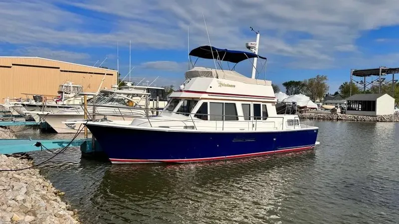 Raindance Yacht Photos Pics 1998 Sabre 36 Fast Trawler docked at a marina under a partly cloudy sky.