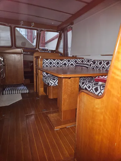 Raindance Yacht Photos Pics 1998 Sabre 36 Fast Trawler interior with wooden finish and patterned seating.