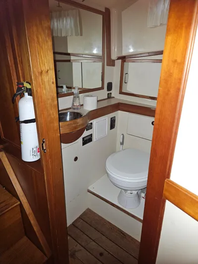 Raindance Yacht Photos Pics 1998 Sabre 36 Fast Trawler bathroom with wooden accents and compact design.
