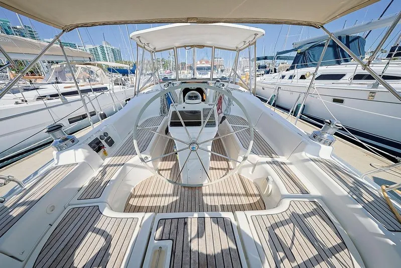 Mustang III Yacht Photos Pics 2007 Beneteau Oceanis 423 sailboat cockpit with wooden deck and steering wheel.