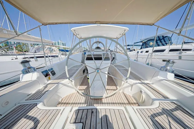 Mustang III Yacht Photos Pics 2007 Beneteau Oceanis 423 sailboat cockpit with steering wheel, docked in marina.