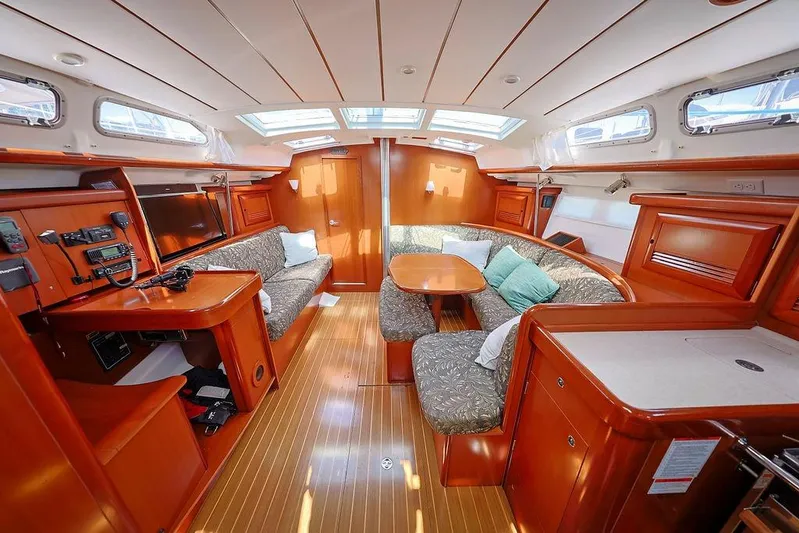 Mustang III Yacht Photos Pics Interior of 2007 Beneteau Oceanis 423 sailboat, featuring cozy seating and elegant wood finishes.