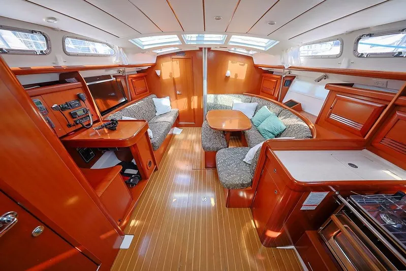 Mustang III Yacht Photos Pics Luxurious interior of 2007 Beneteau Oceanis 423 sailboat with wood finish and cozy seating.