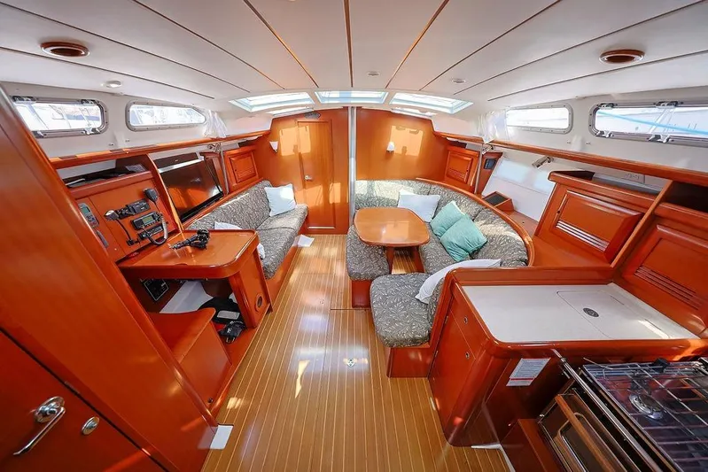 Mustang III Yacht Photos Pics Luxurious interior of 2007 Beneteau Oceanis 423 sailboat with wood finish and cozy seating area.