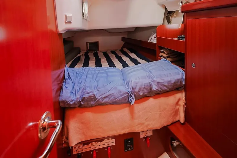 Mustang III Yacht Photos Pics Cozy cabin interior of 2007 Beneteau Oceanis 423 sailboat with striped bedding.