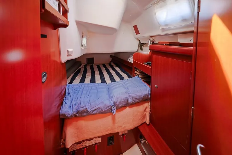 Mustang III Yacht Photos Pics Cozy cabin interior of 2007 Beneteau Oceanis 423 sailboat with striped bedding.