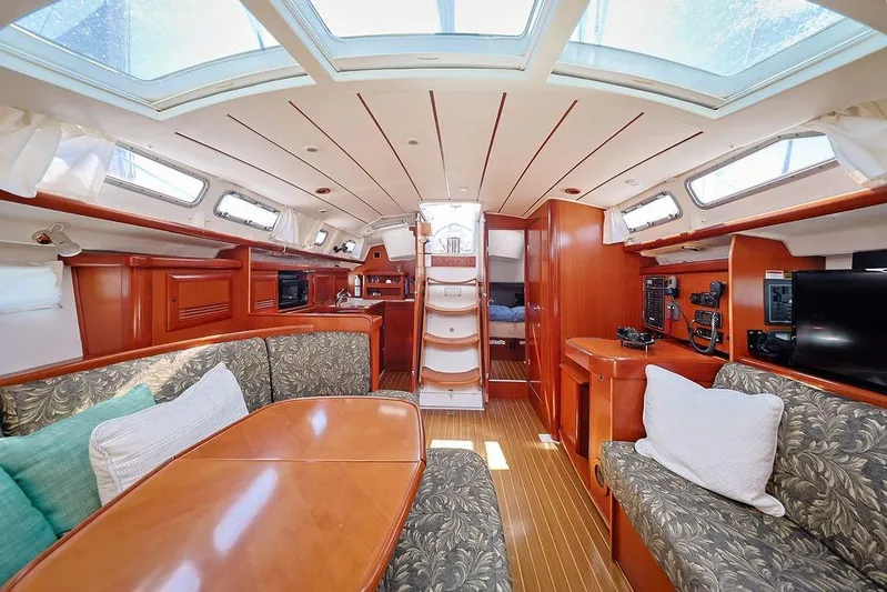 Mustang III Yacht Photos Pics Luxurious interior of 2007 Beneteau Oceanis 423 sailboat with elegant wood finish and skylights.