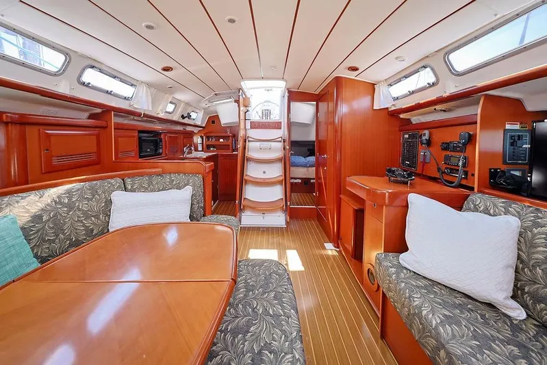 Mustang III Yacht Photos Pics Luxurious interior of 2007 Beneteau Oceanis 423 sailboat with wood finish and comfortable seating.