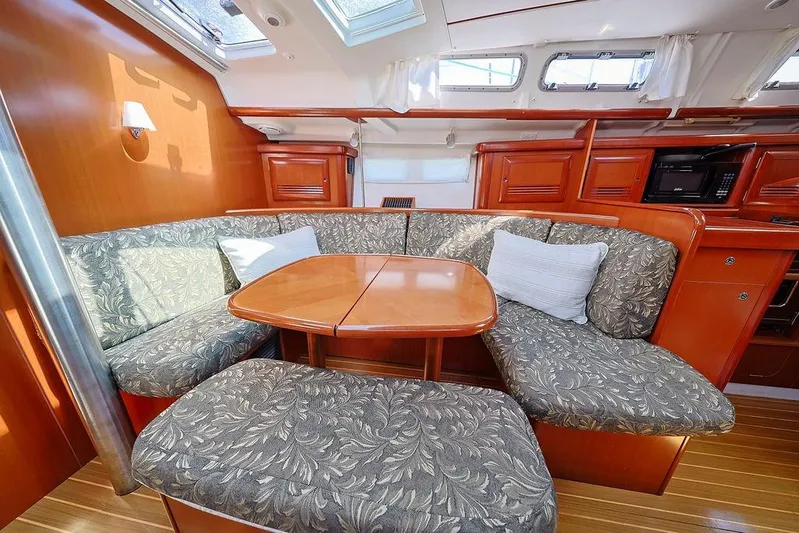 Mustang III Yacht Photos Pics Interior of 2007 Beneteau Oceanis 423 yacht with cozy seating and wooden table.