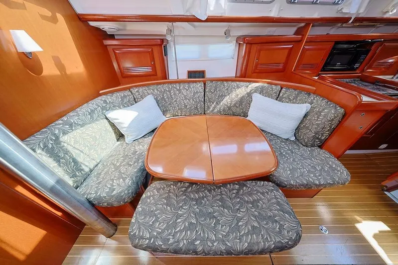 Mustang III Yacht Photos Pics Interior of 2007 Beneteau Oceanis 423 yacht with cozy seating and wooden table.