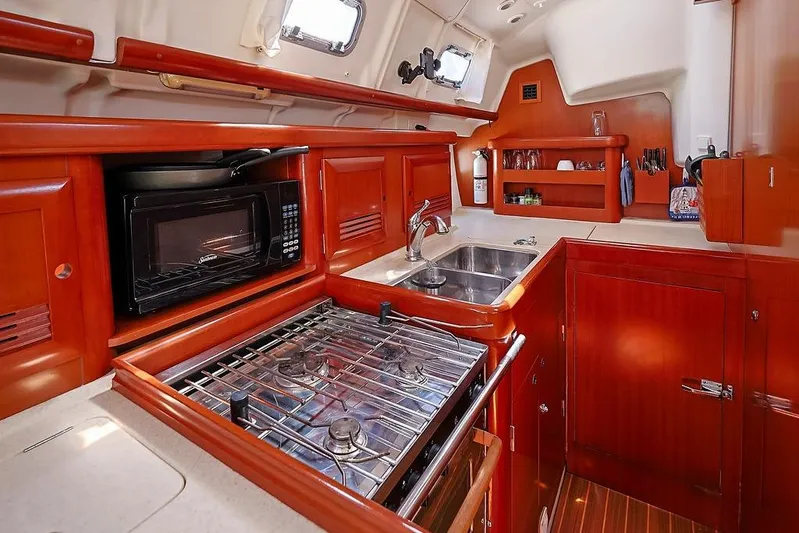 Mustang III Yacht Photos Pics 2007 Beneteau Oceanis 423 yacht kitchen with stove, microwave, and sink.