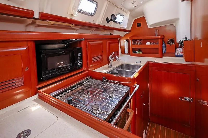Mustang III Yacht Photos Pics Interior of 2007 Beneteau Oceanis 423 yacht kitchen with stove, microwave, and sink.